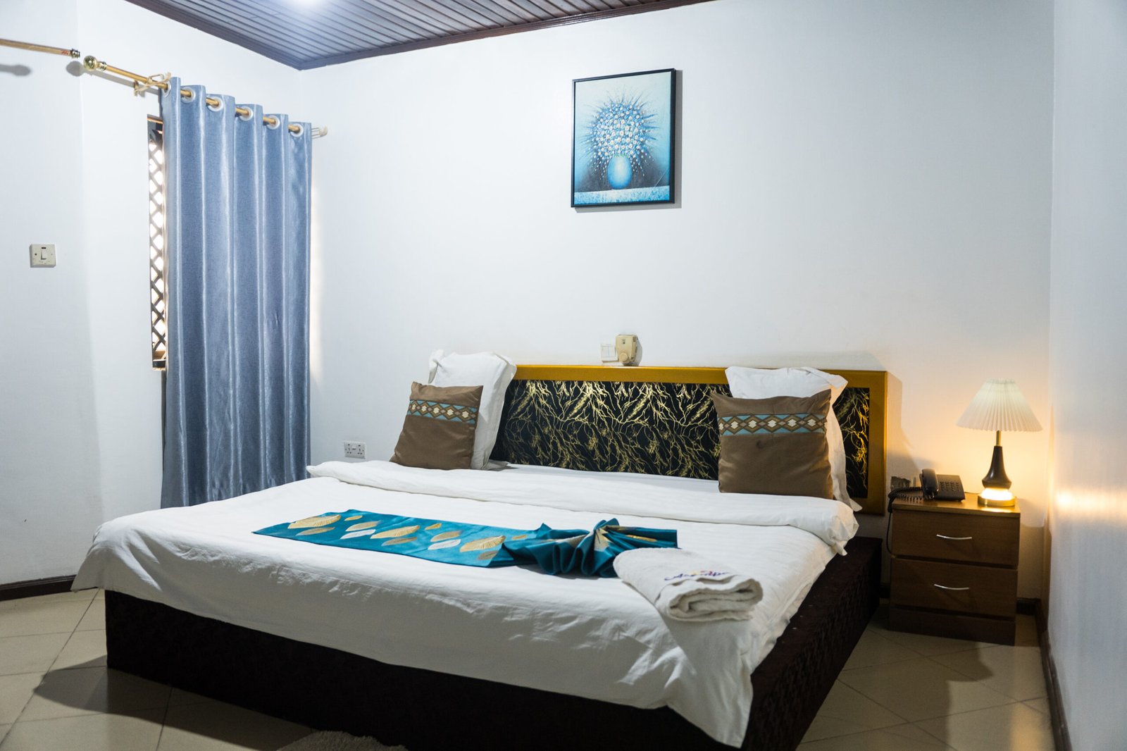 Spacious bedroom featuring a comfortable bed, ceiling fan, and natural light.