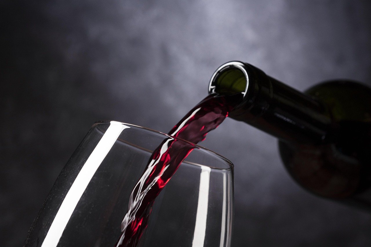 Two elegant wine glasses filled with white wine, captured with a beautiful bokeh effect.